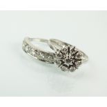 A seven stone diamond ring, the white metal shank stamped '18ct',