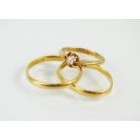 A 22ct gold wedding band, together with a single stone old cut diamond ring,