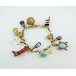 A yellow metal bracelet with attached charms, to include; banded agate 'shoes',