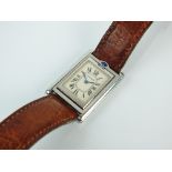 A Cartier stainless steel reverso wristwatch, the oblong white dial with Roman numerals,