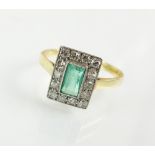 An emerald and diamond rectangular cluster ring, the yellow metal shank stamped '18ct', ring size J,