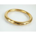 A 9ct gold faceted hollow bangle, weight 18.