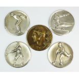 Five uni face white and bronzed metal plaques, probably German, depicting various sportsmen,