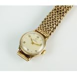 A Lady's 9ct gold Omega wristwatch, the circular silvered dial with Arabic numerals, manual wind,