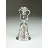 A continental white metal wager cup, indistinctly stamped, modelled as a woman, 10cm high, weight 2.