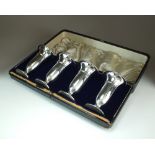 A George V cased set of four silver mounted posy vases, A & J Zimmerman, Birmingham 1910,