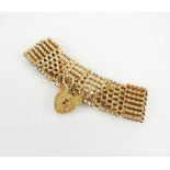 A 9ct gold seven bar gate link bracelet, with heart shaped padlock clasp, weight 24.