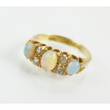 An early 20th century 18ct gold seven stone opal and diamond ring,