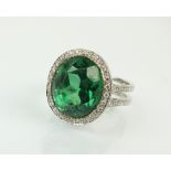 A green stone and diamond dress ring,