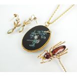 A garnet and seed pearl ant brooch, together with an inlaid opal pendant depicting two birds,