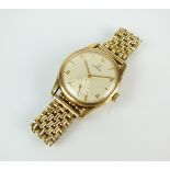 A Gentleman's 9ct gold Omega wristwatch, the silvered dial with Arabic numerals,