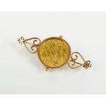 A sovereign set bar brooch, dated 1913, within yellow metal scroll mount,