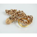 A yellow metal hollow curb link bracelet, the heart shaped padlock clasp stamped '9ct',