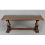 A reproduction Multiyork oak refectory type dining table with cleated ends on two heavy square