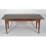A 19th century elm and fruit wood farmhouse table the boarded top with cleated ends,