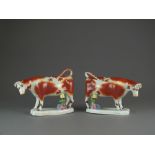 A pair of Staffordshire milkmaid cow creamers, circa 1860, lacking stoppers,