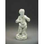 A Derby biscuit porcelain model of a young boy holding a hat of flowers accentuated in blue,