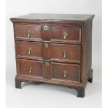 A William and Mary and later oak chest of three long drawers,