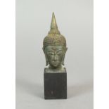 A Burmese bronze head of Buddha, 19th century, depicted with a serene expression,