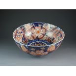 A Japanese Imari punch bowl, Meiji period, of rounded form with lobed and barbed rim,