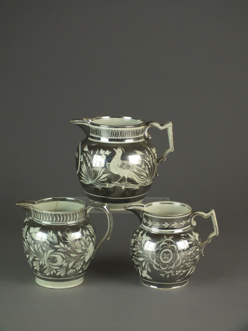 Three English pearlware silver lustre jugs, early 19th century, one named and dated 'Hannah Ivens,
