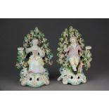 A pair of Chelsea-Derby bocage figural candlestick groups, circa 1765,