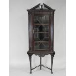 A mahogany Chippendale style straight front corner cabinet on stand the pierced architectural