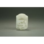 A Chinese near white jade buckle, Qing Dynasty, of rectangular form with slightly rounded ends,