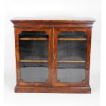 A Regency rosewood veneered low floor standing bookcase the two later glazed doors revealing two