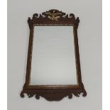 An 18th century style mahogany scroll cut mirror with phoenix carved pediment over a rectangular