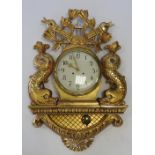 A large giltwood cartel type wall clock, the eight day movement striking on a single bell,