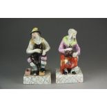 A pair of Staffordshire pearlware figure of Jobson and Nell, circa 1800-1820, on marbled bases, 17.