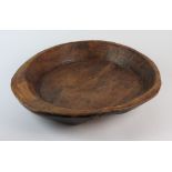 A late 18th/early 19th century primitive bowl of circular flared rim form, 46cm diameter, 8.