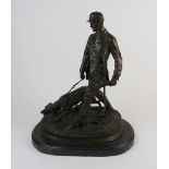 A modern bronze figure group of huntsman and hound on a black marble base,