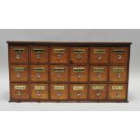 A 19th century mahogany apothecary chest of eighteen short drawers,