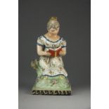 A Staffordshire pearlware 'Sherratt-type' figure of the 'Reading Maiden', circa 1820, 23.