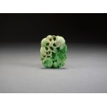 A Chinese mottled pale green jadeite pendant, Qing Dynasty,