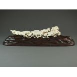 A Japanese ivory figure group of horses, Meiji/Taisho period, carved as six galloping horses,