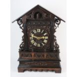 A late 19th century stained oak cuckoo mantel / bracket clock,