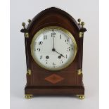 An Edwardian mahogany boxwood strung lancet shape mantel clock the 6 inch convex dial with ring of