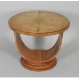 An Art Deco burr maple veneered circular occasional table, on U support and circular base,