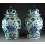 A large pair of Chinese blue and white jars and covers, 20th Century, of ovoid form,