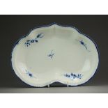 A Caughley kidney shaped dessert dish painted in the Chantilly Sprigs pattern within a fine basket