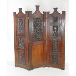 A Victorian oak Aesthetic three section room divider, the eight carved panels by Edwin Ridgeway,