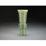 A Chinese celadon jade archaistic beaker vase, Gu, late Qing Dynasty,