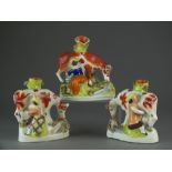 A pair of Staffordshire spill vase groups as male and female milking cows, 19th century,