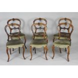 A set of six mid Victorian walnut balloon back salon side chairs on cabriole front legs terminating