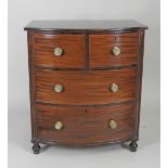 A William IV mahogany bow front chest of two short over two long cockbeaded drawers fitted with