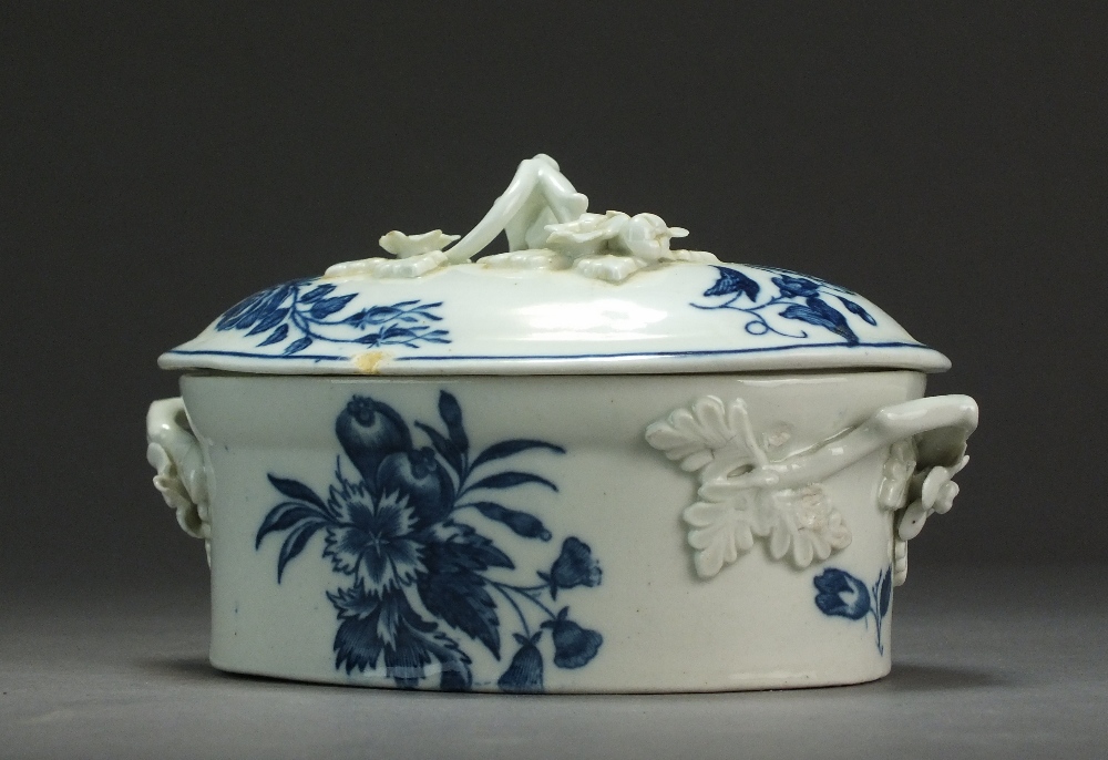 A Caughley oval butter dish and cover transfer-printed in the Pine Cone and Three Flowers patterns,