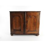 An early Victorian rosewood tabletop collectors cabinet the two single arch panel doors opening to